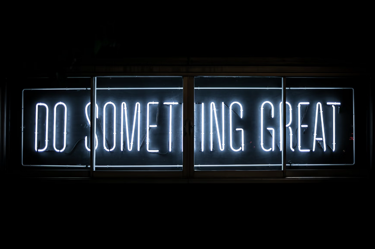 Neon sign displaying the message "Do Something Great" to encourage positive actions and responsible choices