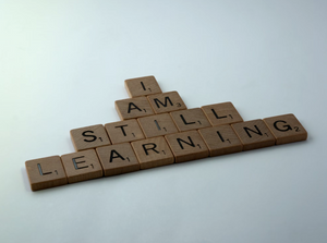 Scrabble tiles arranged to spell 'I AM STILL LEARNING' on a white background, symbolizing continuous learning, growth mindset, and personal development. Lockhold liquid kratom online free kratom sample